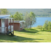 Place de stationnement pour camping-car - 10 small nostadiske hytter med 2-4 sengeplasser. Minikjøkken uten innlagt vann og avløp, derfor er servicebygget tilrettelagt med alt. Rett ved fjorden, midnattssola, naturbaserte opplevelser og minner for livet. - Sandnes Fjord Camping