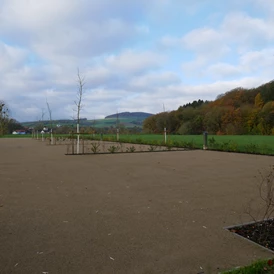 Wohnmobilstellplatz: Buchten mit wassergebundener Decke und frischer Bepflanzung. Im Hintergrund: Blick auf den Deiselberg - Trendulas Paradies - Tor zum Reinhardswald