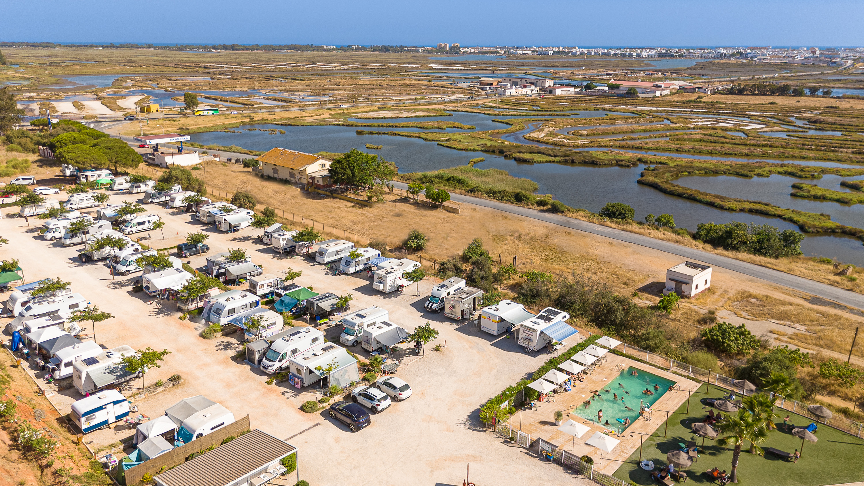 kampeerplaats voor campers - Costa de la Luz - Vista aérea de Camper Park Playas de Luz, área de autocaravanas, campers y caravanas en Isla Cristina (Huelva), junto al Paraje Natural Marismas de Isla Cristina. Amplias parcelas, piscina, zonas verdes y acceso directo a rutas ciclistas de la Costa de la Luz. - Camper Park Playas de Luz